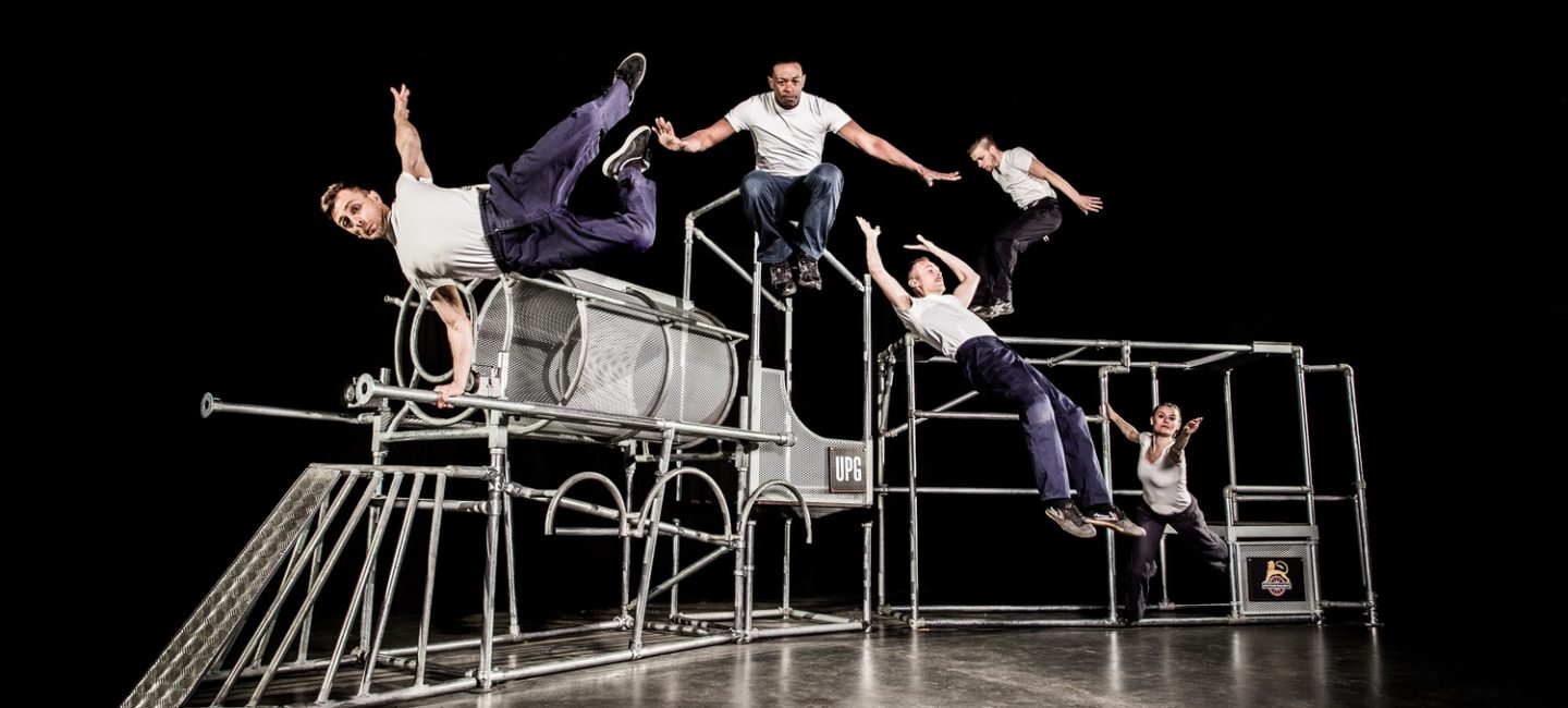 Dancers mid aid on a scaffold made locomotive